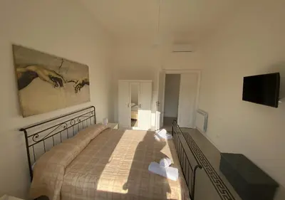 a bedroom with a bed and a painting on the wall at Dew Vatican Apartment in Rome