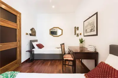 a bedroom with a bed and a table and a desk at Idyllia - Classy apartment in Vatican area in Rome