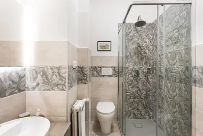 a bathroom with a shower and a toilet and a sink at Idyllia - Classy apartment in Vatican area in Rome
