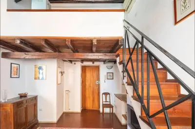 a staircase in a house with a wooden door at Accogliente casa al Pantheon in Rome