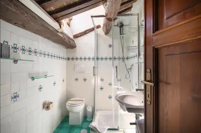 a bathroom with a shower and a toilet and a sink at Accogliente casa al Pantheon in Rome
