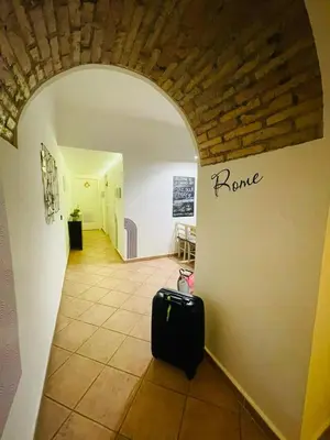 a room with a hallway with a black suitcase at La Cornice Apartment in Rome