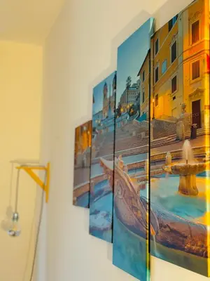 a group of pictures hanging on a wall at La Cornice Apartment in Rome