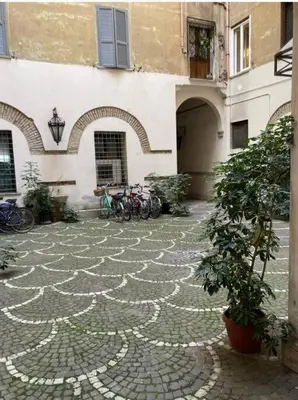 a stone courtyard with bikes parked next to a building at Loft Accogliente - Piazza San Giovanni in Rome