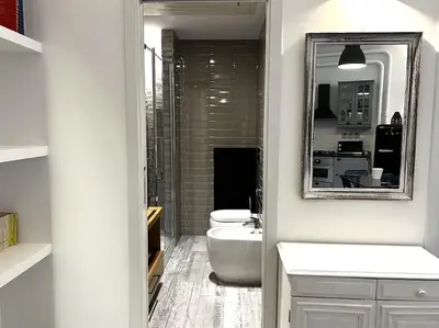 a bathroom with a sink and a toilet and a mirror at Modern Apartment near the Vatican in Rome