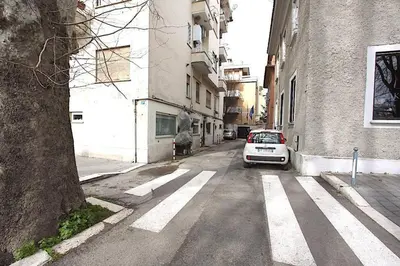a car parked on a street next to a building at Ponte Milvio Lovely Studio in Rome
