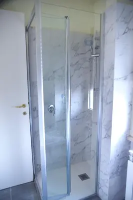 a shower with a glass door in a bathroom at stazione trastevere\u516c\u5bd3 in Rome