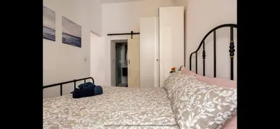 a bedroom with a bed with a black frame at Leonidas’s House in Rome