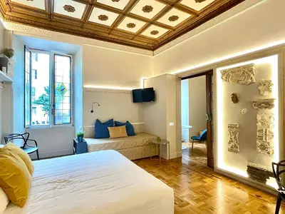 a bedroom with a large white bed and a window at Z-ArchSuites Urbs in Rome