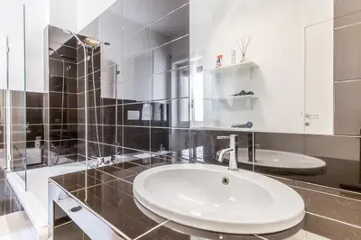 a white bathroom with a sink and a mirror at Real Vatican Inn in Rome