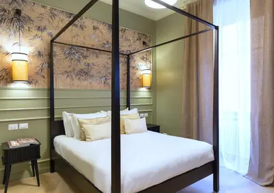 a bedroom with a four poster bed in a room at MAISON CAIO 7 in Rome