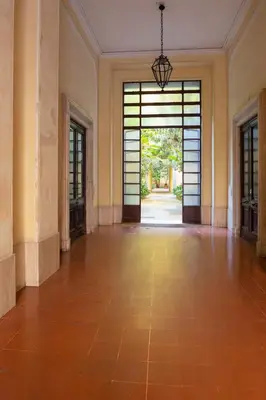 an empty room with a large door and a hallway at MAISON CAIO 7 in Rome
