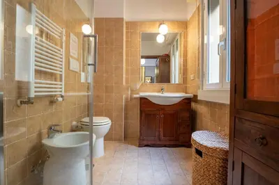 a bathroom with a toilet and a sink and a mirror at Rialto Apartment Vatican Museums in Rome
