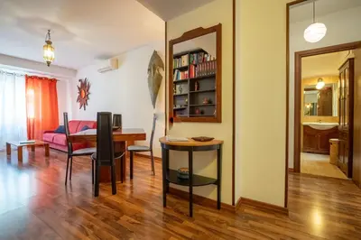 a living room with a table and a desk at Rialto Apartment Vatican Museums in Rome