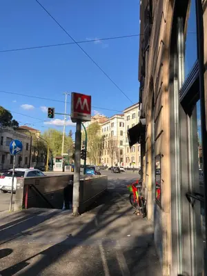 a sign on the side of a building on a street at The Manzoni in Rome