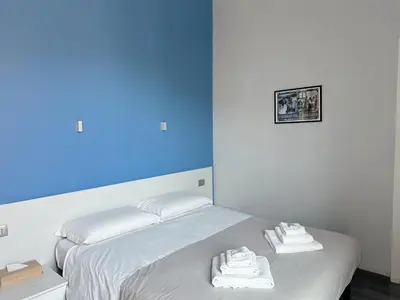 a white bed with towels on top of it at The Manzoni in Rome