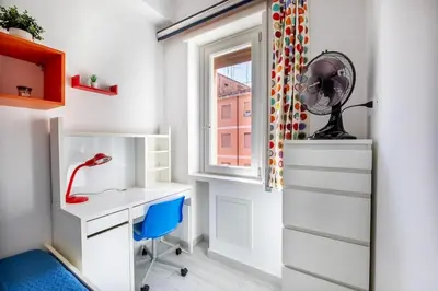 a home office with a desk and a fan at Casa Sosò... La casa che fa per te! in Rome