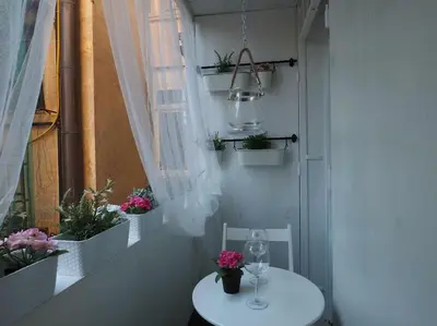 a white table with a wine glass and a window at VATICAN CITY 76 Apartment in Rome