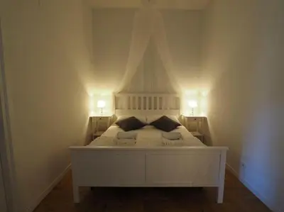 a bedroom with a white bed with two pillows at VATICAN CITY 76 Apartment in Rome