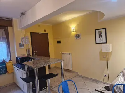 a kitchen with a counter and stools in a room at casa alibrandi in Rome
