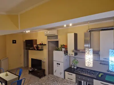 a kitchen with a white refrigerator and a stove at casa alibrandi in Rome