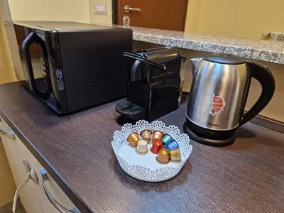 a counter with a coffee pot and a plate of candy at casa alibrandi in Rome
