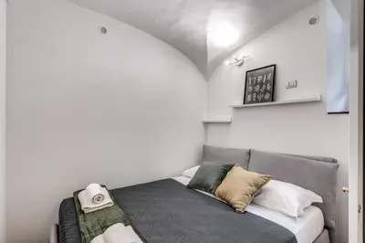 a small room with a bed with pillows on it at Residenza Caprera in Rome