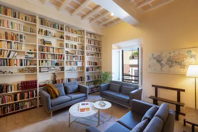 a living room with couches and bookshelves at Amazing Campo de' Fiori in Rome