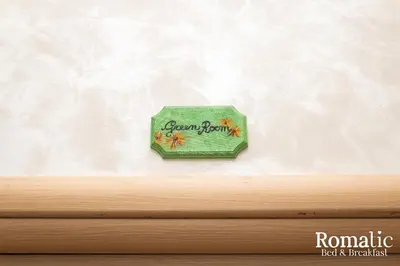 a green box hanging on a wall at Romatic in Rome