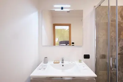 a bathroom with a sink and a mirror at Il Pontefice Luxury in Rome
