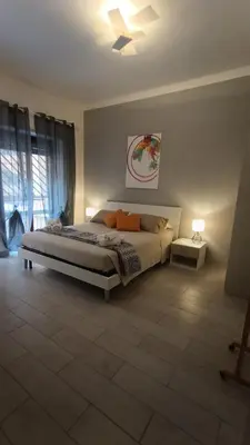 a bedroom with a bed and a ceiling fan at Casilina One in Rome