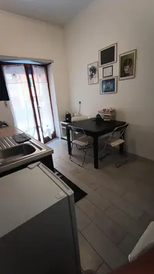 a living room with a desk and a table at Casilina One in Rome
