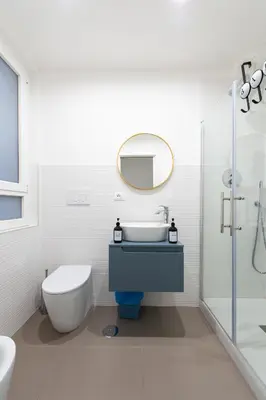 a bathroom with a sink and a toilet and a mirror at St. Peter Boutique Apt in Rome