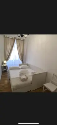 a bedroom with a bed and a chair and a window at Panorama suites & flats in Rome