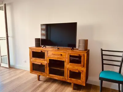 a wooden entertainment center with a flat screen television on it at Luxury apartment Balduina - Casa di Irene in Rome