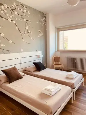 a bedroom with two beds and a window at Luxury apartment Balduina - Casa di Irene in Rome
