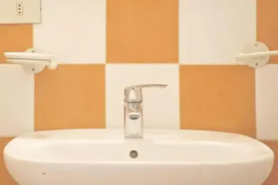 a bathroom sink with a faucet on top of it at Casa Particular Vintage in Rome