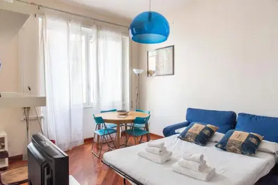 a living room with a blue couch and a table at Here's a new Laura's place - close to San Pietro in Rome