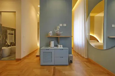 a bathroom with a vanity with a mirror and a sink at Dea Rome Suites in Rome