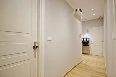 an empty hallway with a white door and a table at Roma Nostra Luxury B&B in Rome