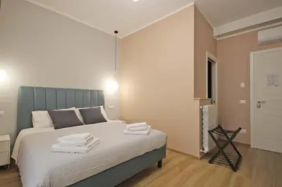 a bedroom with a bed with towels on it at Roma Nostra Luxury B&B in Rome
