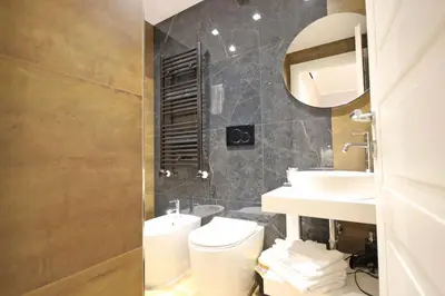 a bathroom with a toilet and a sink and a mirror at Roma Nostra Luxury B&B in Rome