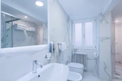 a white bathroom with a sink and a toilet at Casa Prefetti 46 B in Rome