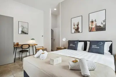 a bedroom with a large bed and a table at Limehome Rome via dei Reti in Rome