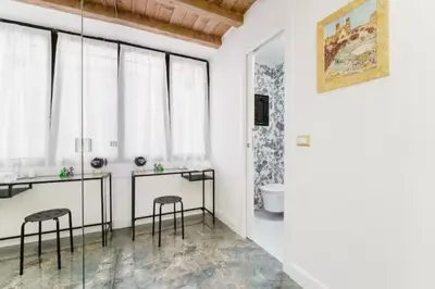 a bathroom with two tables and two stools at Pav Suite Rome in Rome