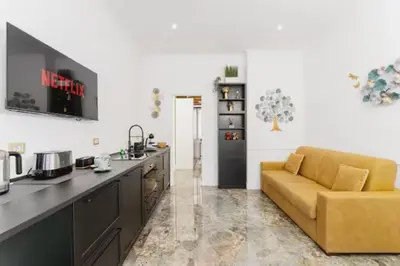 a kitchen with a yellow couch in a living room at Pav Suite Rome in Rome