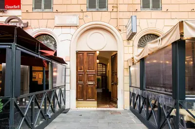 an entrance to a building with a wooden door at GuestHost - Largo Leopardi Modern Apartment in Rome