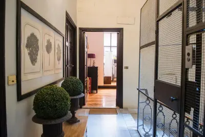 a hallway with two potted plants on a wall at Vittorio Apartment Rome in Rome