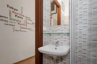 a bathroom with a sink and a mirror at central little basic apartment in Rome