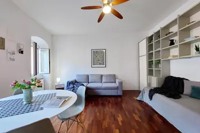 a living room with a couch and a ceiling fan at Cozy Navona Flat in Rome